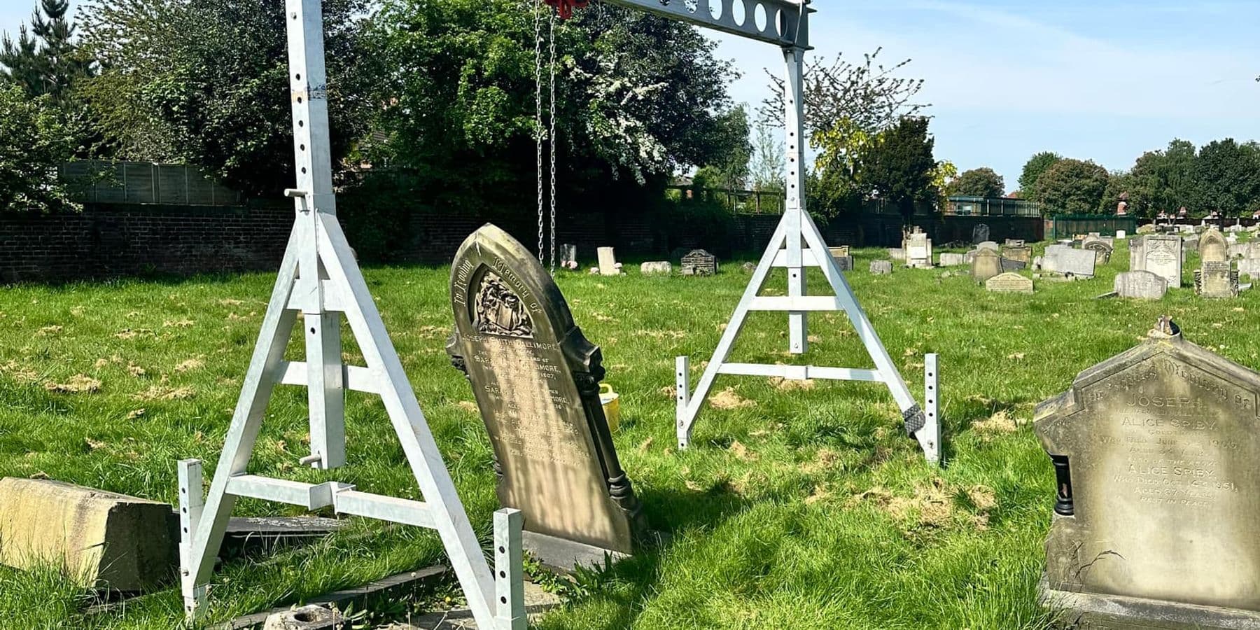 Specialist lifting frame positioned over the memorial