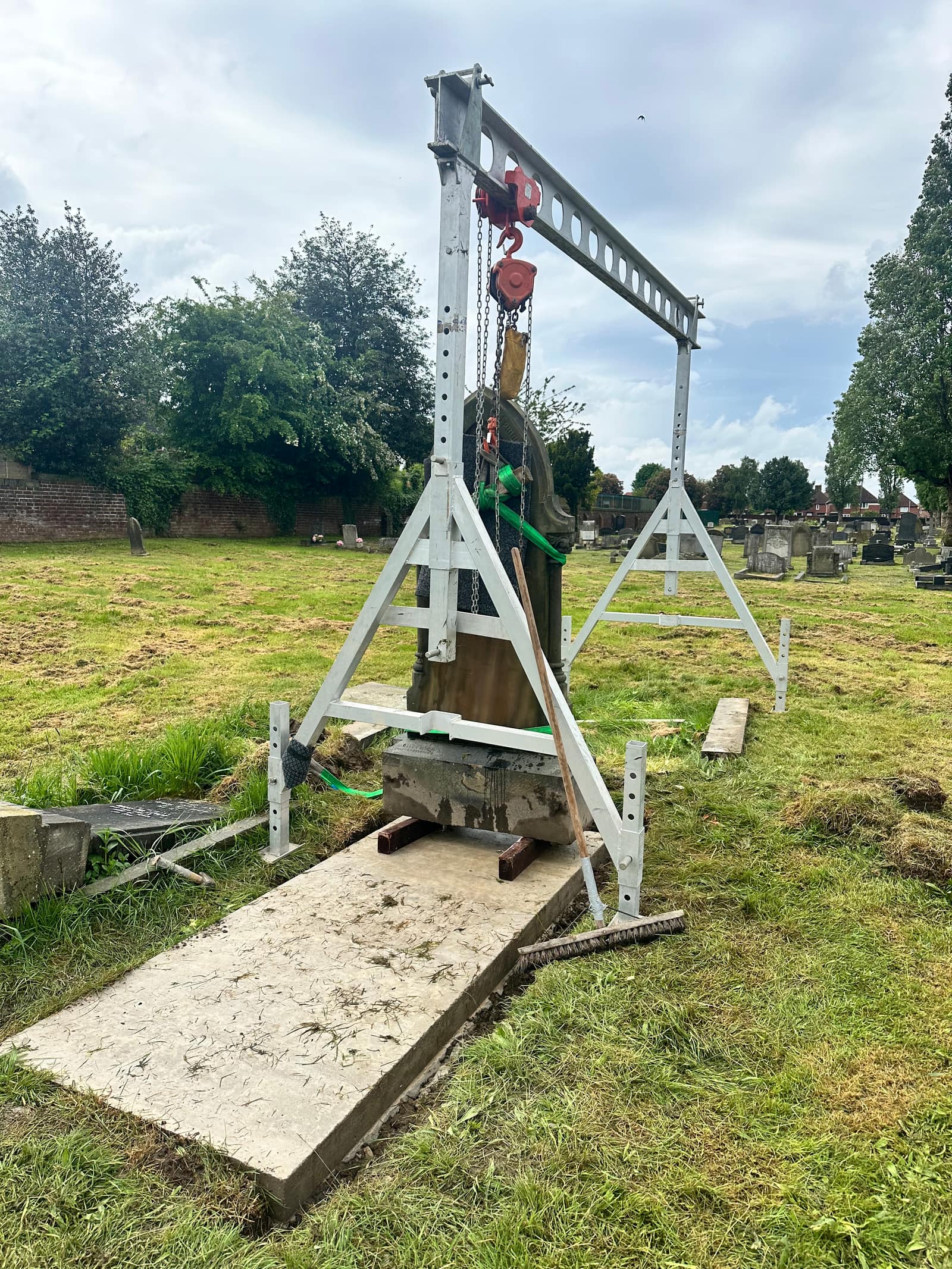 The memorial being carefully lowered onto its new foundation