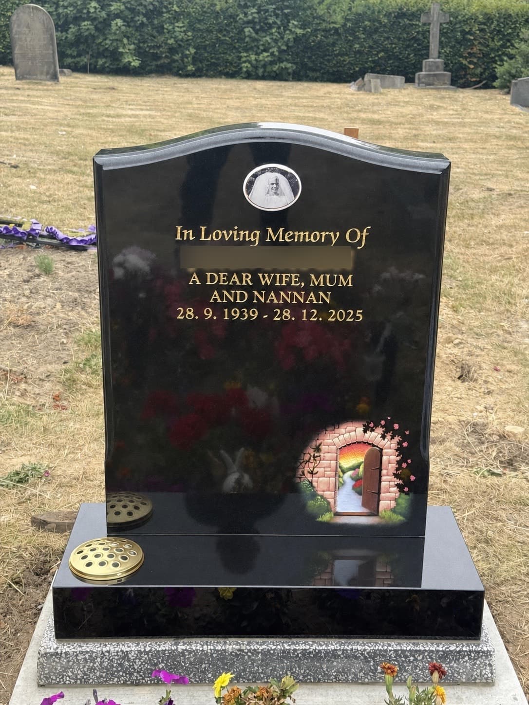 Black granite memorial with garden artwork