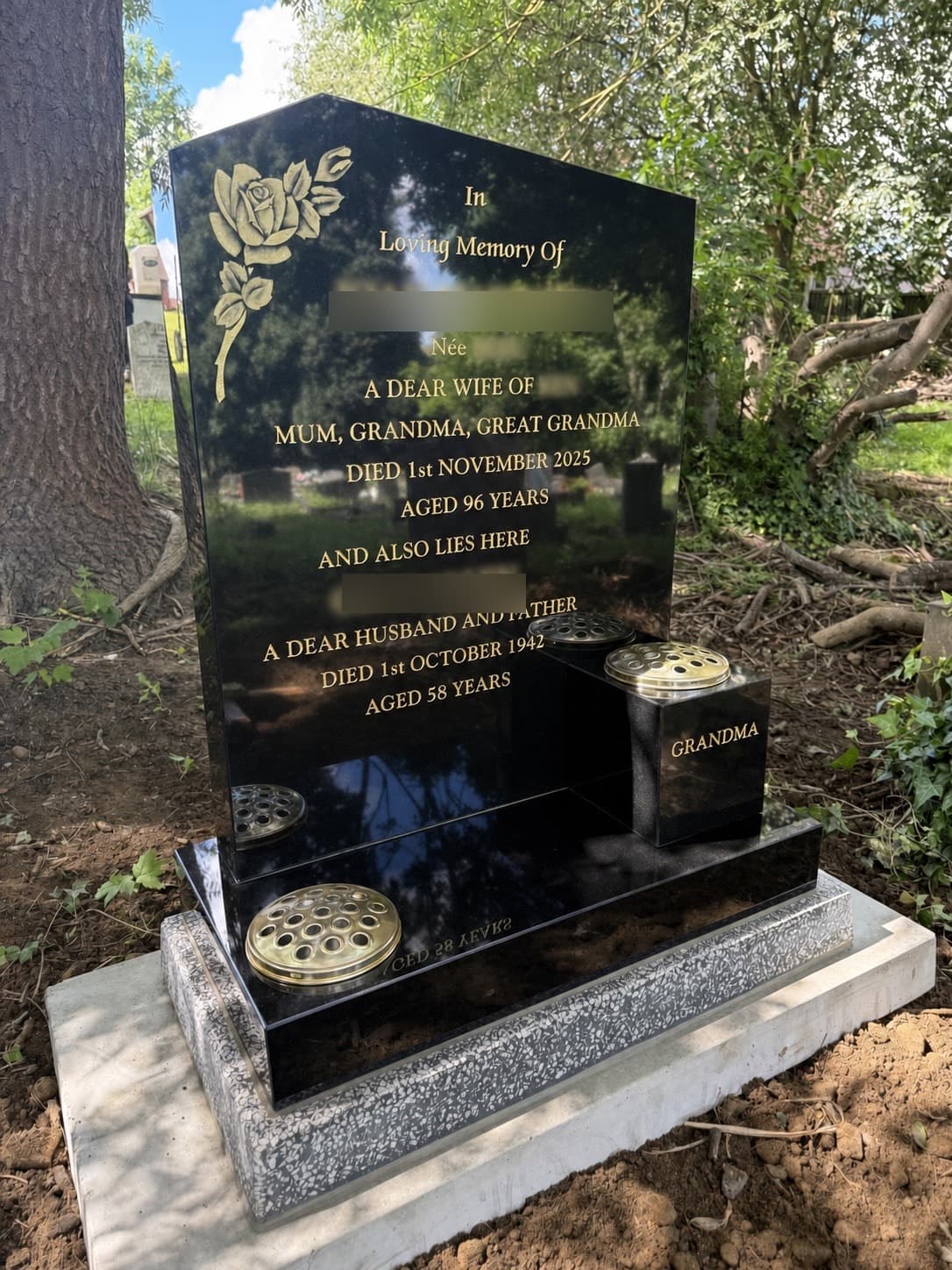 Black granite memorial with gold rose detail