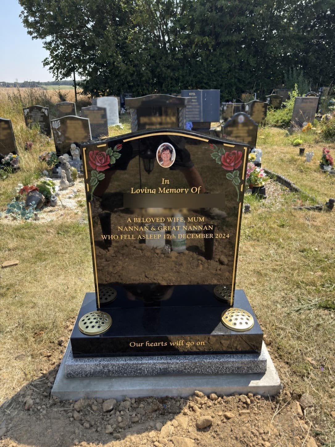 Black granite memorial with painted roses