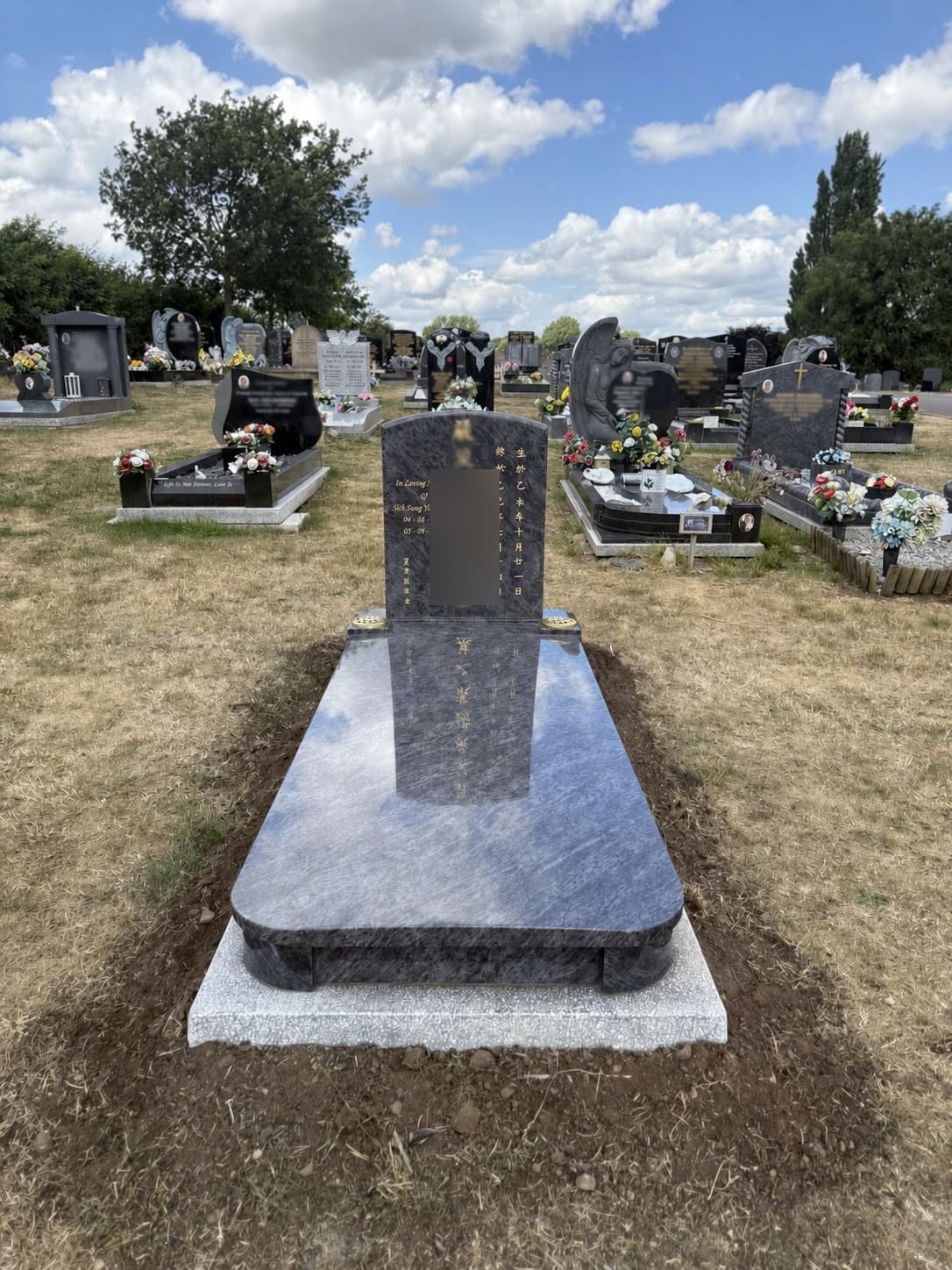 Full-length grey granite kerb memorial